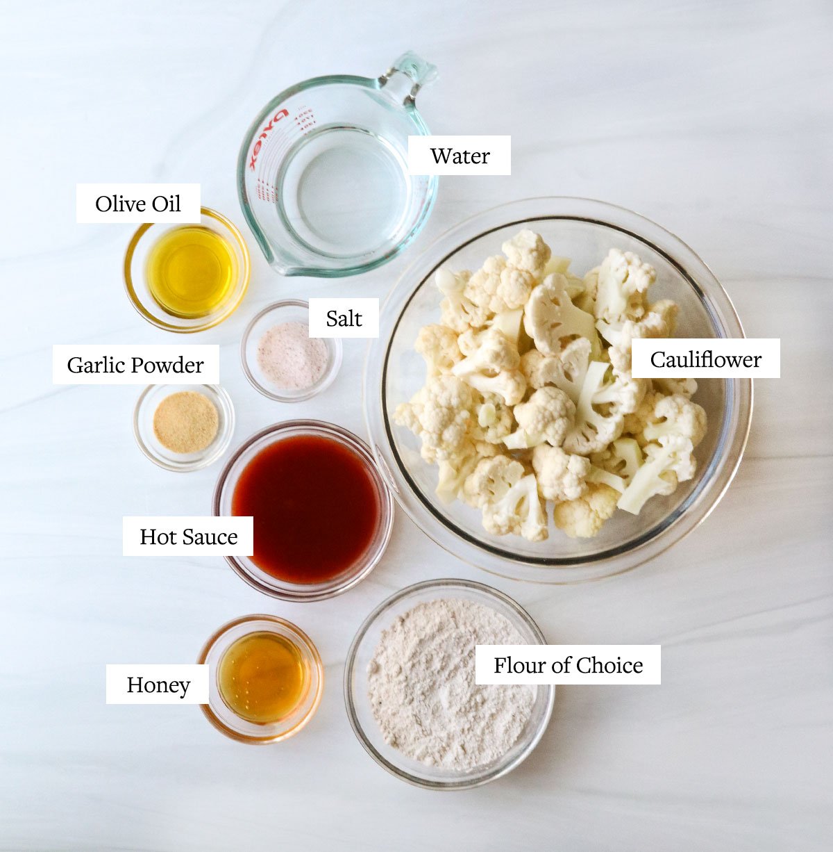 air fryer buffalo cauliflower ingredients labeled in glass bowls.