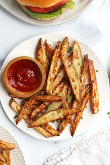 air fryer fries on white plate with ketchup