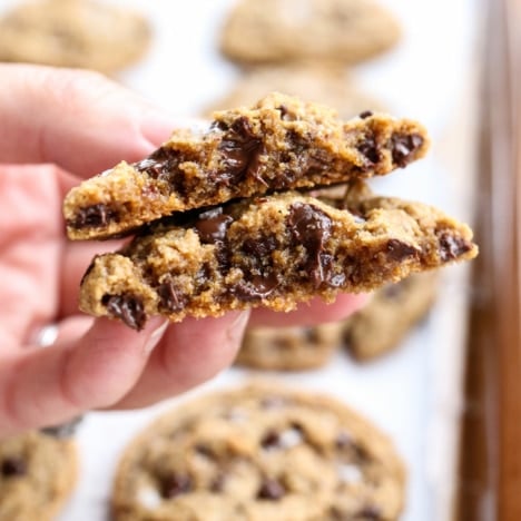 hand holding an almond flour cookie split in half.