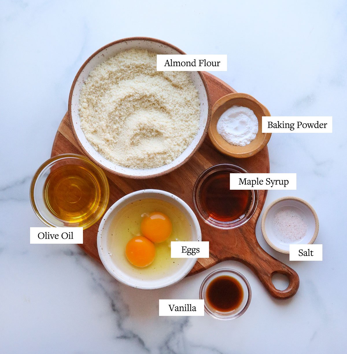 almond flour pancake ingredients labeled on a wooden cutting board.