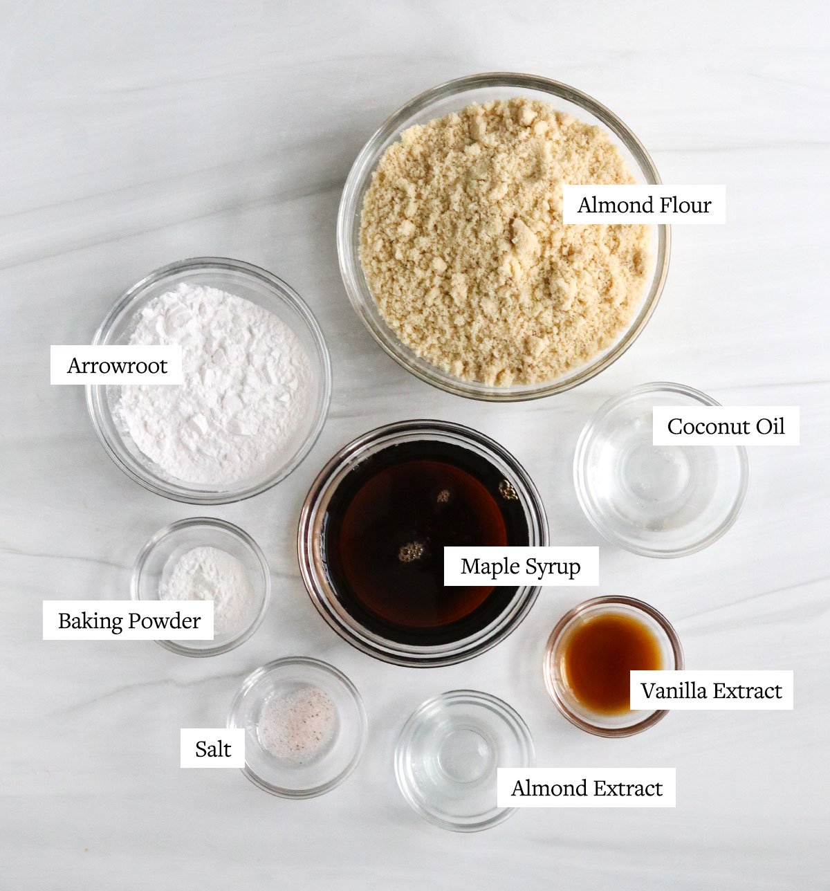 almond flour sugar cookie ingredients labeled in glass bowls.