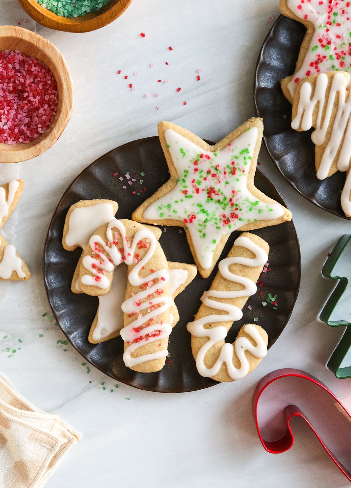 almond flour sugar cookies on black plate.