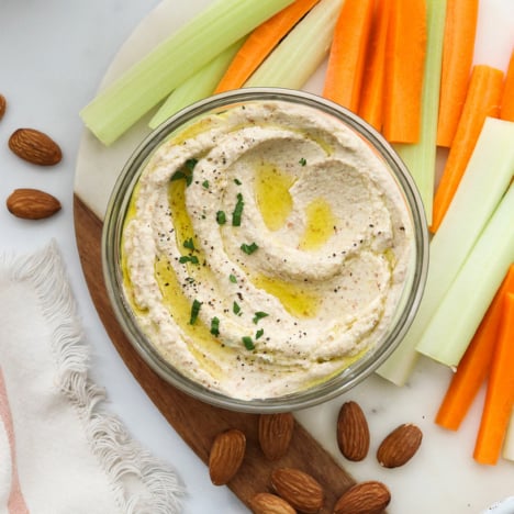 almond pulp hummus served with carrots and celery sticks.