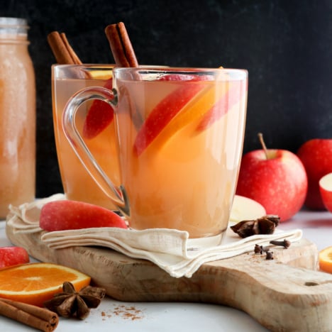 apple cider mugs in front of black surface