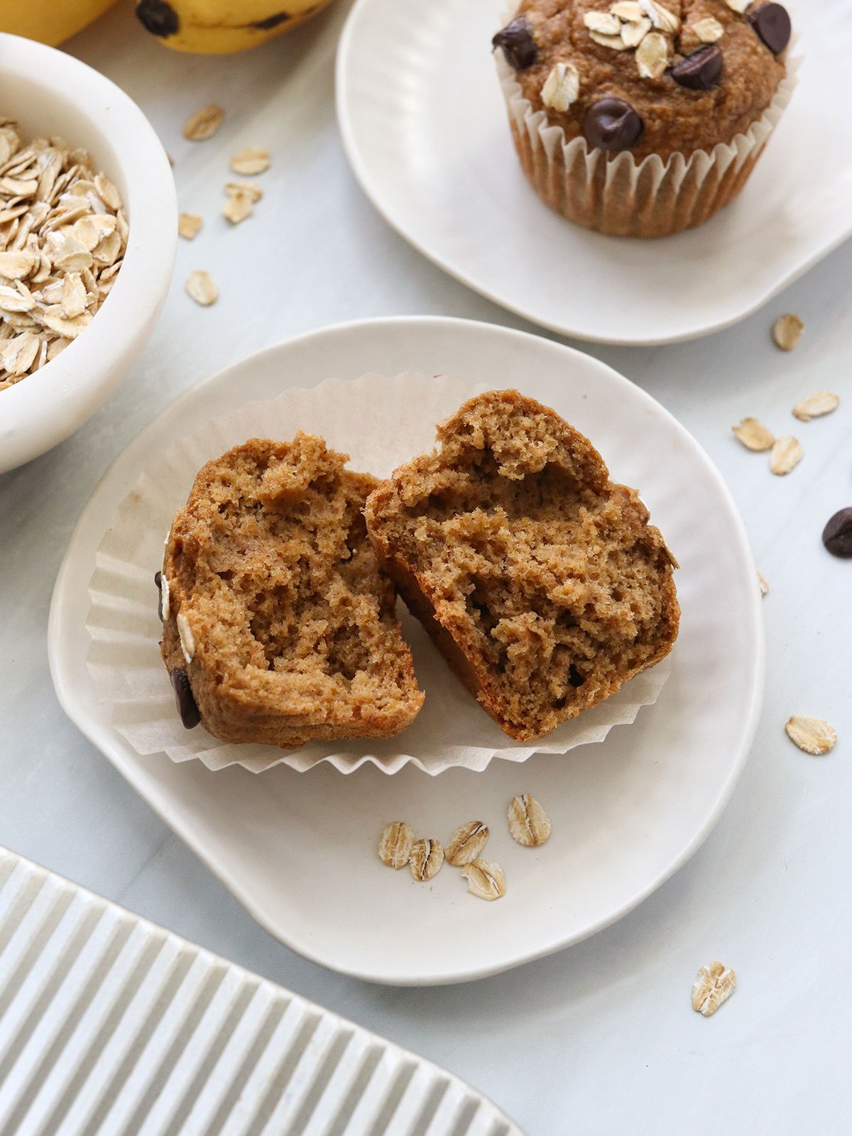 banana oatmeal muffin split in half to show texture.