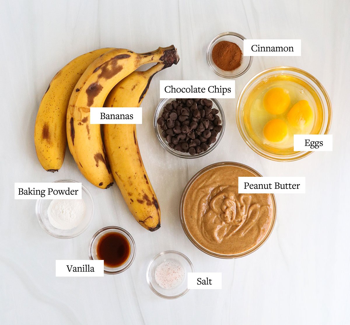 banana snack cake ingredients labeled in glass bowls.