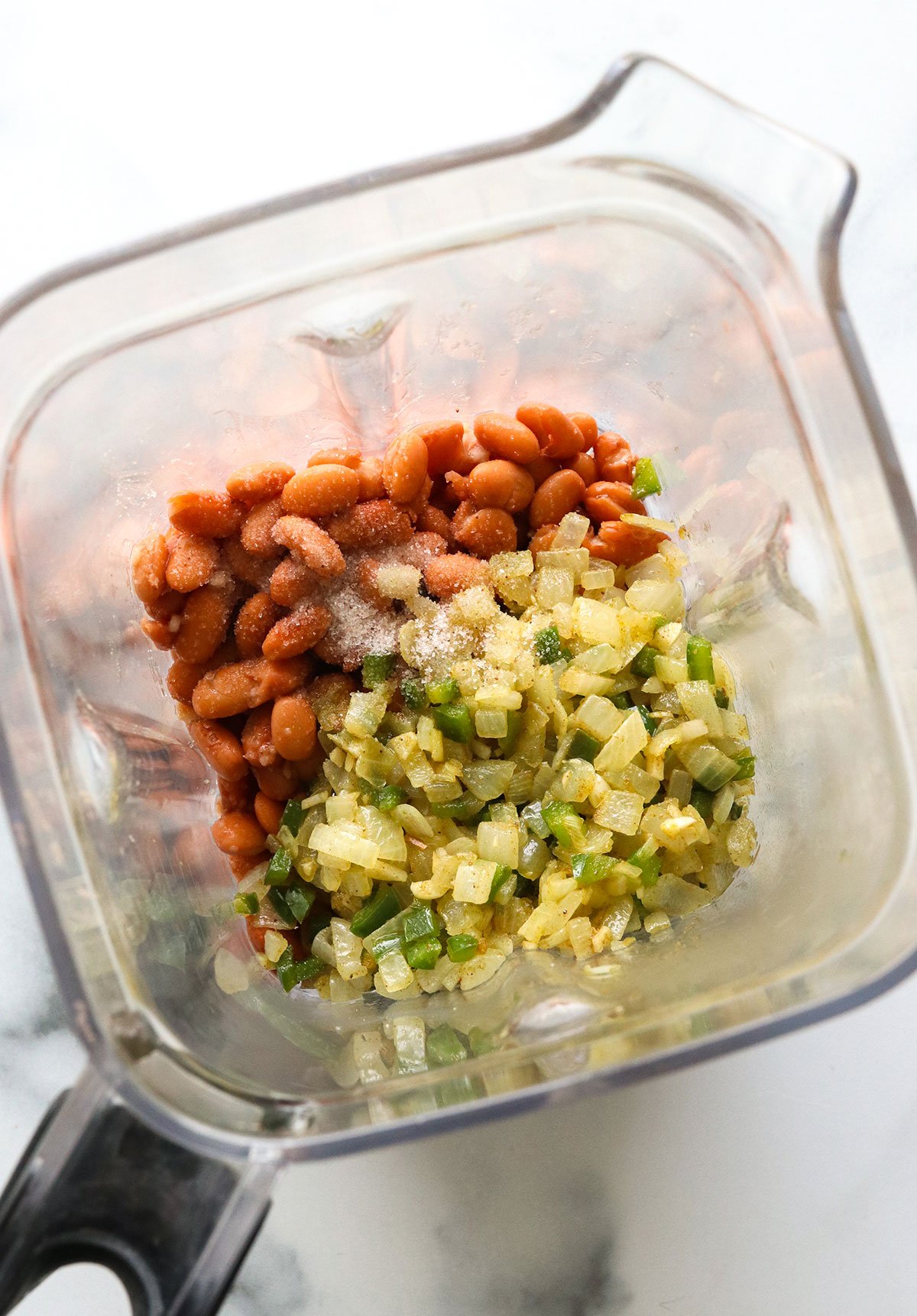 Bean dip ingredients in a blender container.