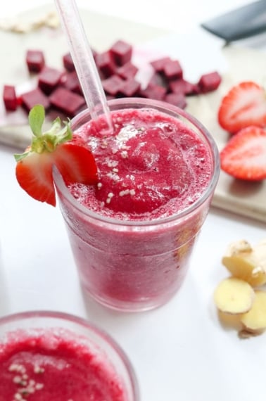 beet smoothie with strawberry on the side