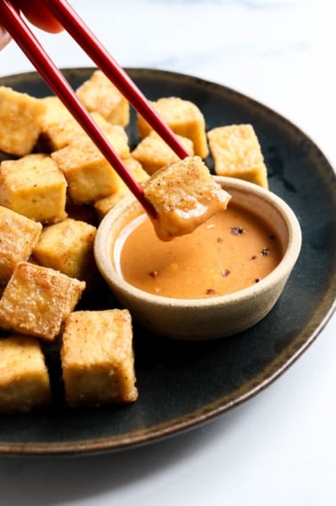 baked tofu dipped in sauce