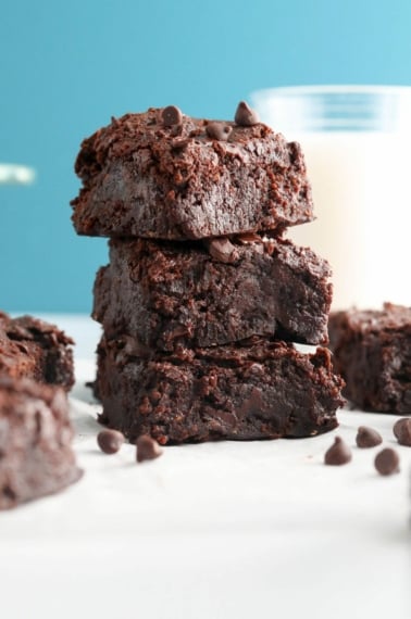 black bean brownies stacked with blue background