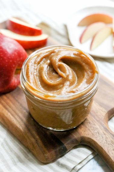 date caramel dip in a glass jar on wooden board.