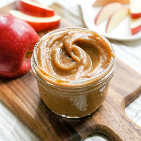 date caramel dip in a glass jar on wooden board.