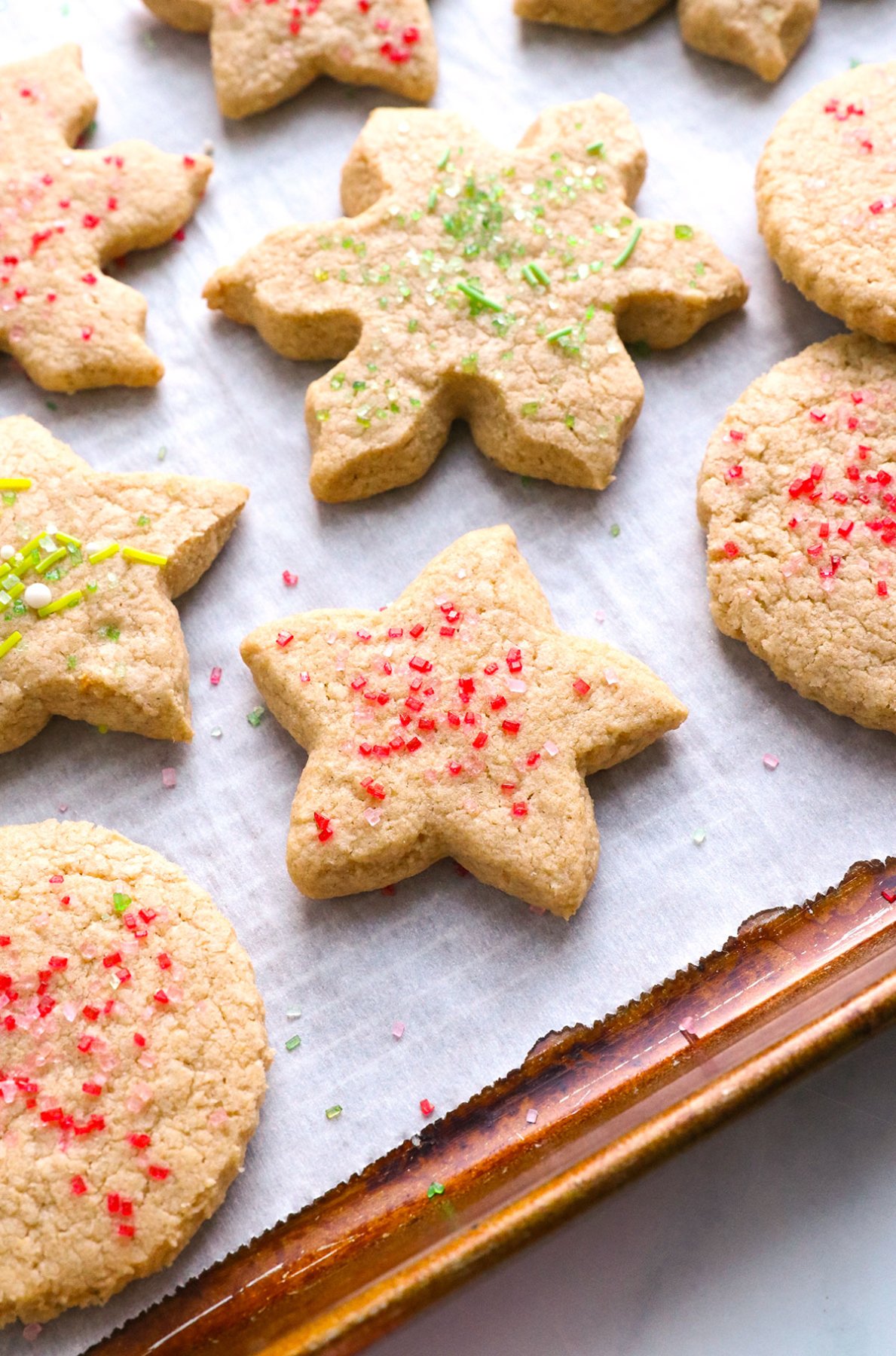 baked oat flour sugar cookie topped with green and red sugar.