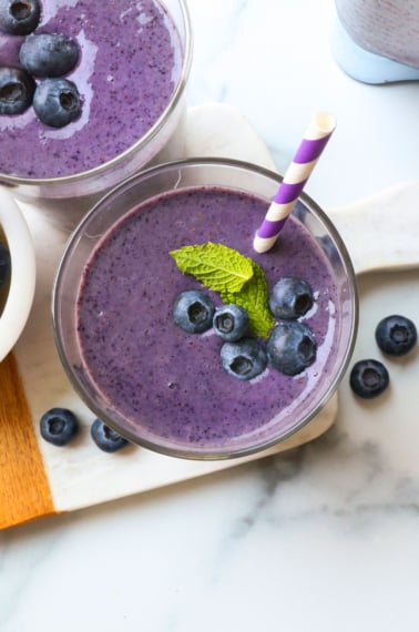 blueberry smoothie topped with berries and mint.