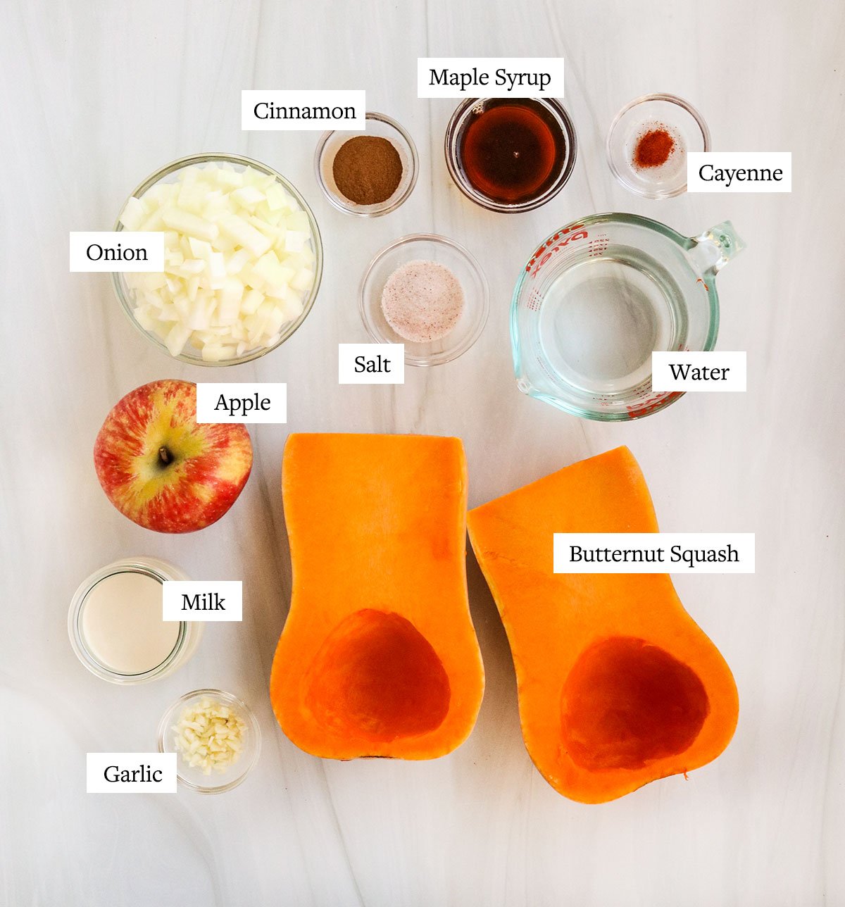 butternut squash soup ingredients labeled on white surface.