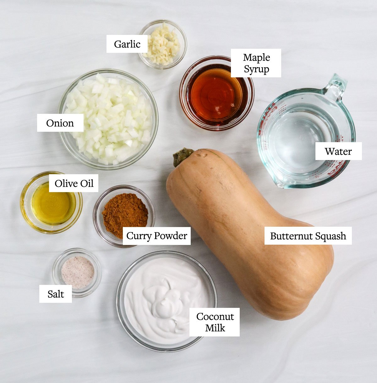 butternut squash soup ingredients labeled in glass bowls.