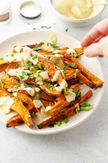 dairy free roasted cauliflower "cheese" sauce on sweet potato fries