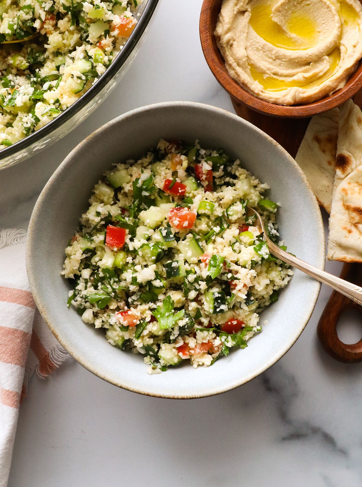 cauliflower tabbouli served in a bowl with a fork.