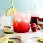 cherry limeade garnished with lime slices.