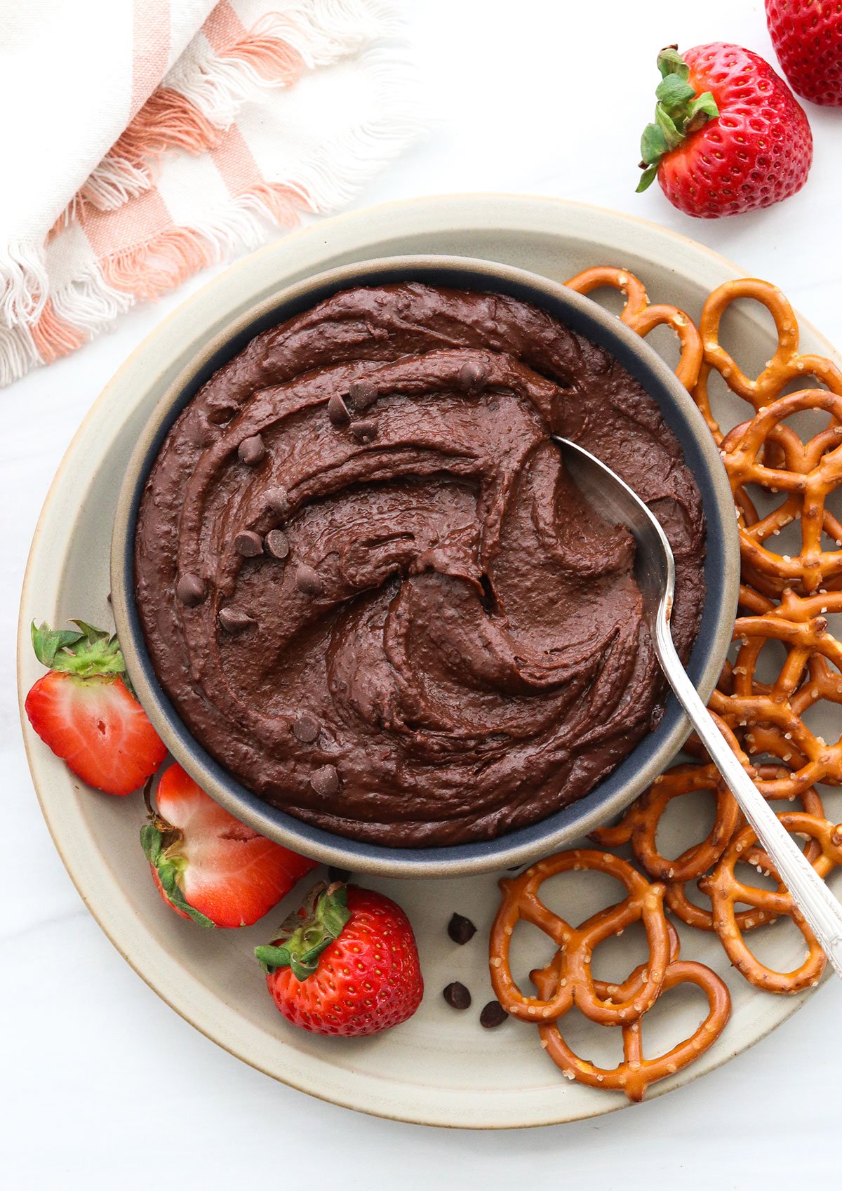 chocolate hummus served with fruit and pretzels.