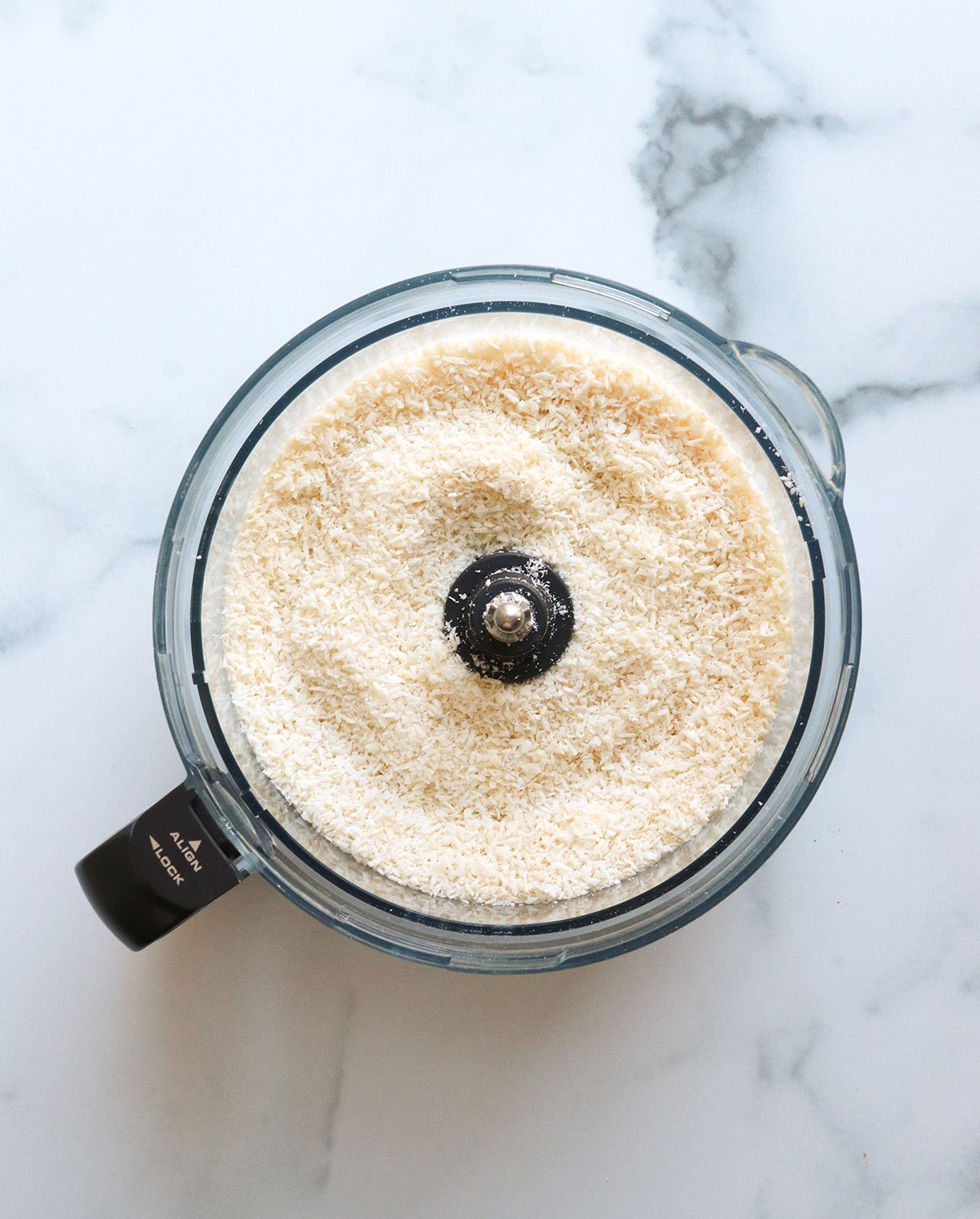 shredded coconut filling a 12-cup food processor.