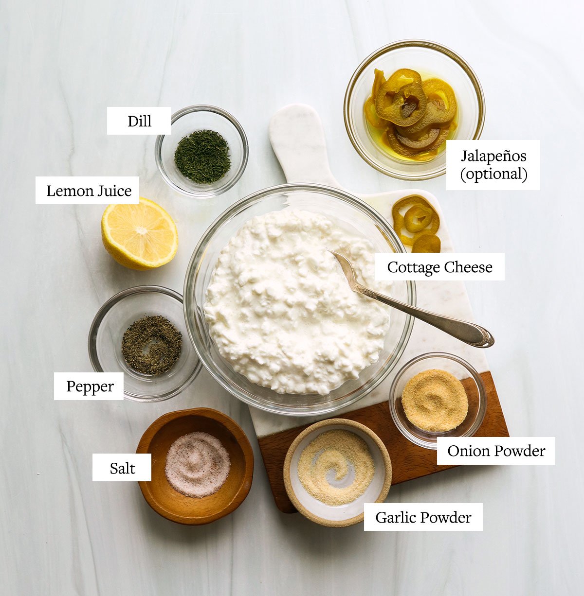 cottage cheese, lemon, and dried spices labeled in glass bowls.