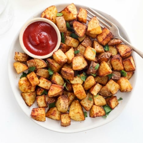 air fryer potatoes with ketchup on plate