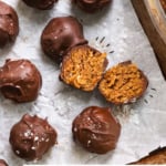 crispy peanut butter ball cut in half on a pan and labeled for pinterest.