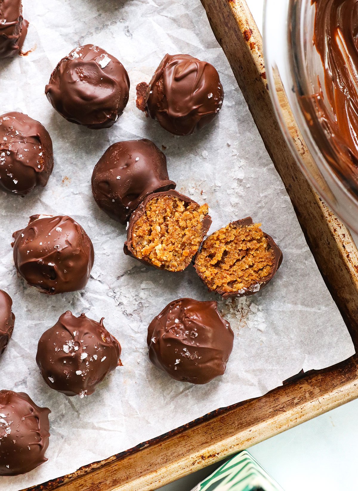 crispy peanut butter ball split in half on a pan.