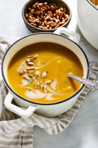 curried butternut squash soup with seeds on top.