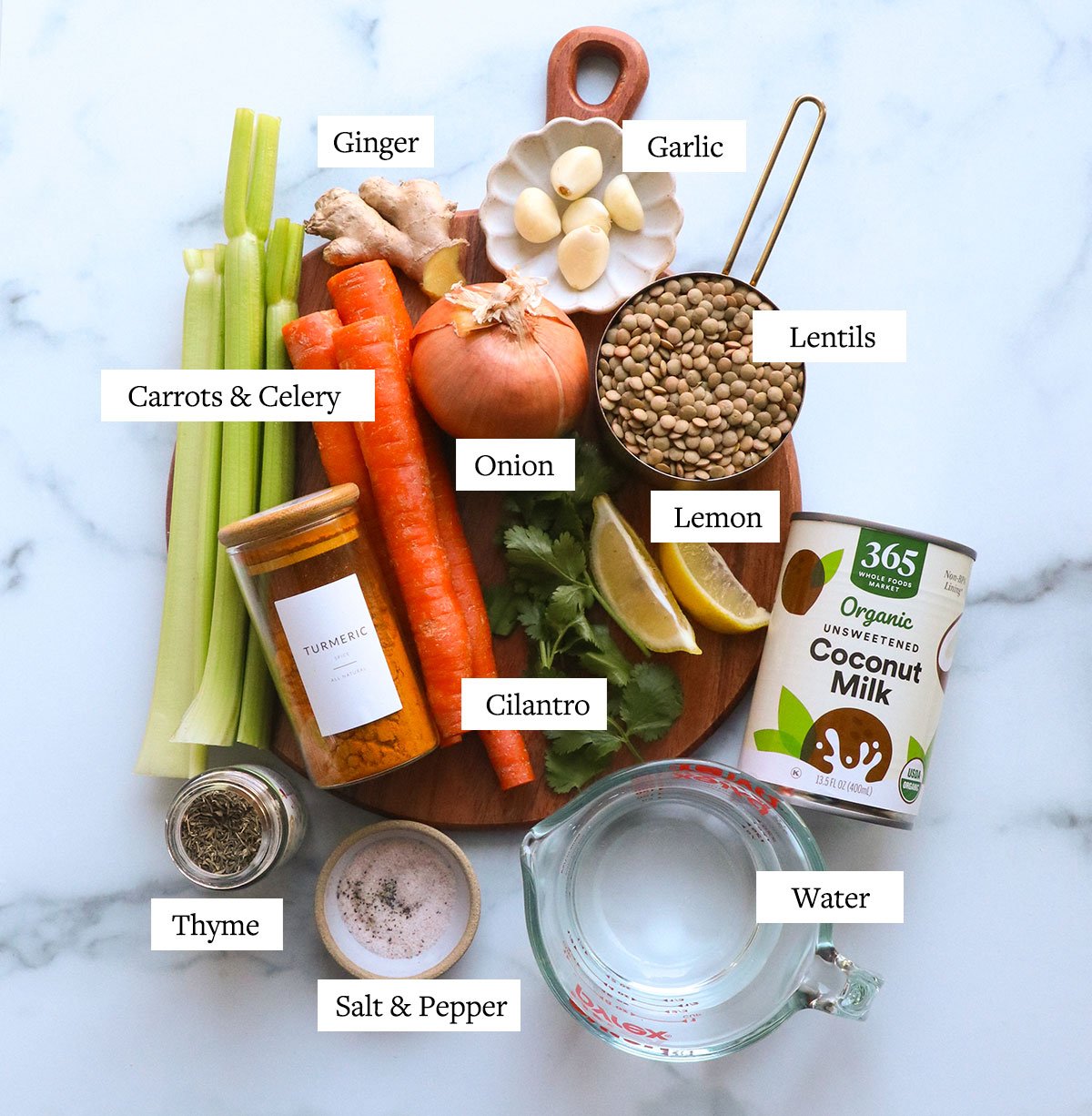 carrots, celery, onion, garlic, lemon, cilantro, lentils, and spices labeled on a cutting board.