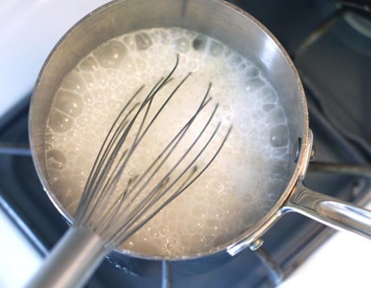 boiling coconut milk on the stove