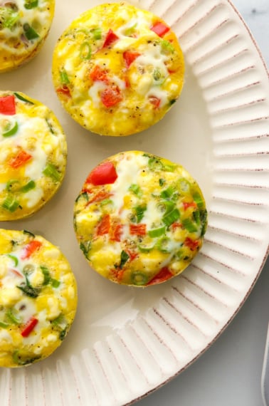 Egg muffins cooling on a white plate.