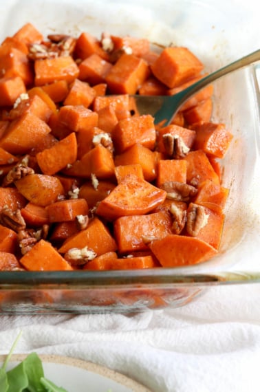 glazed sweet potatoes in dish with pecans