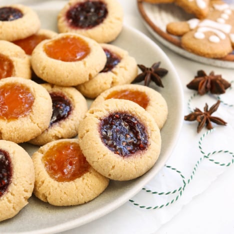 Almond flour thumbprint cookies on a plate.