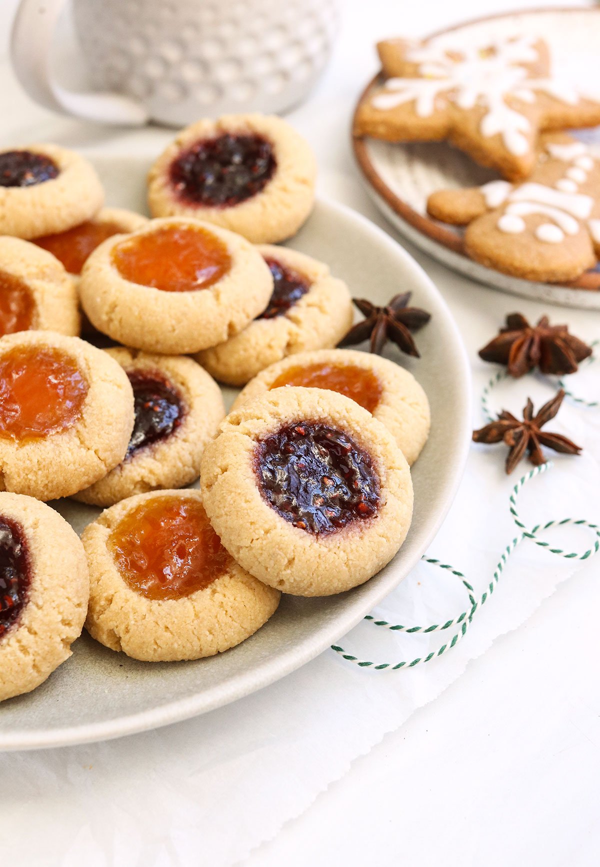 Almond flour thumbprint cookies on a plate.