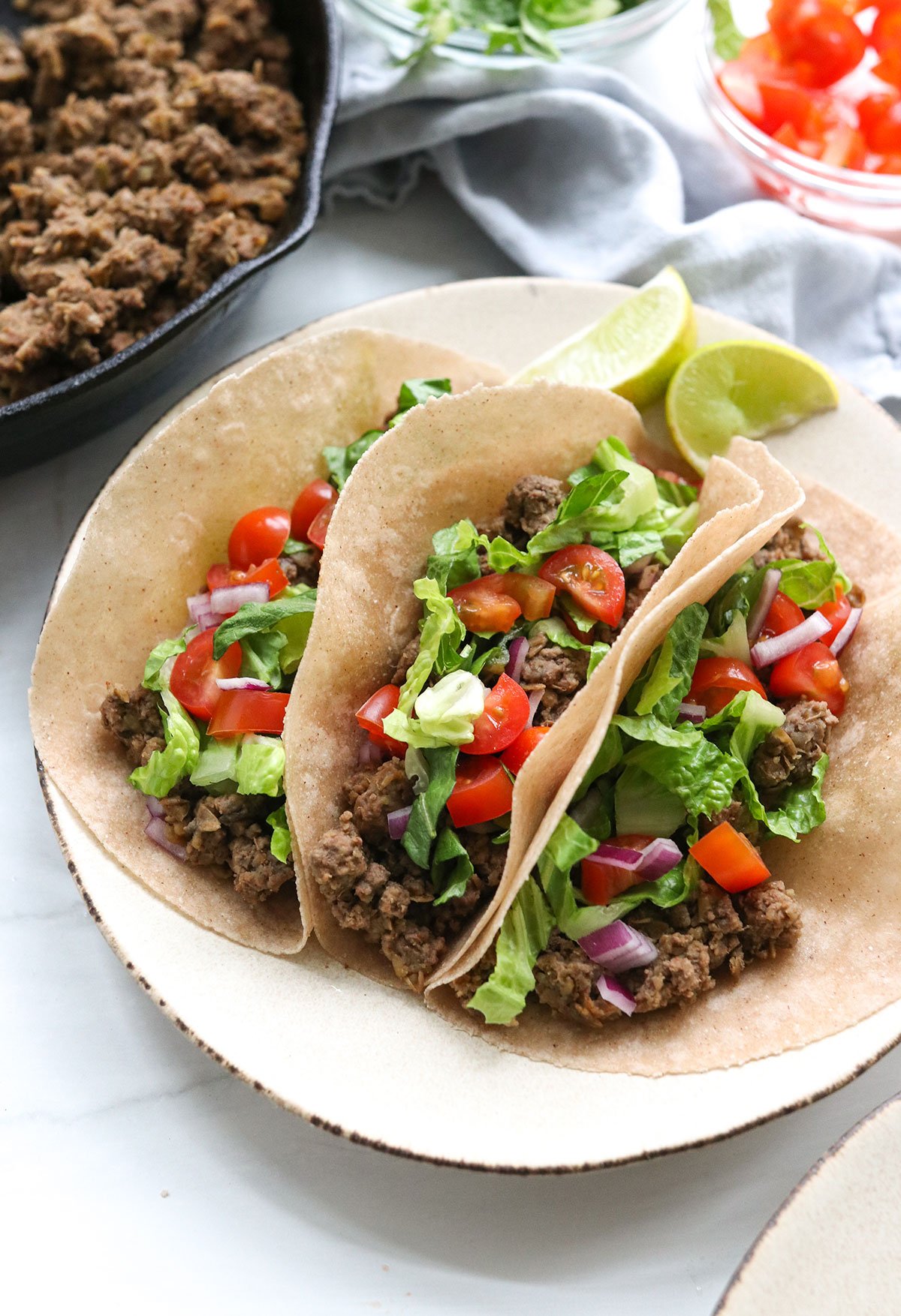 3 healthy ground beef tacos on a serving plate.