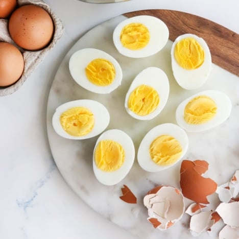 Instant Pot hard boiled eggs cut in half on a marble board