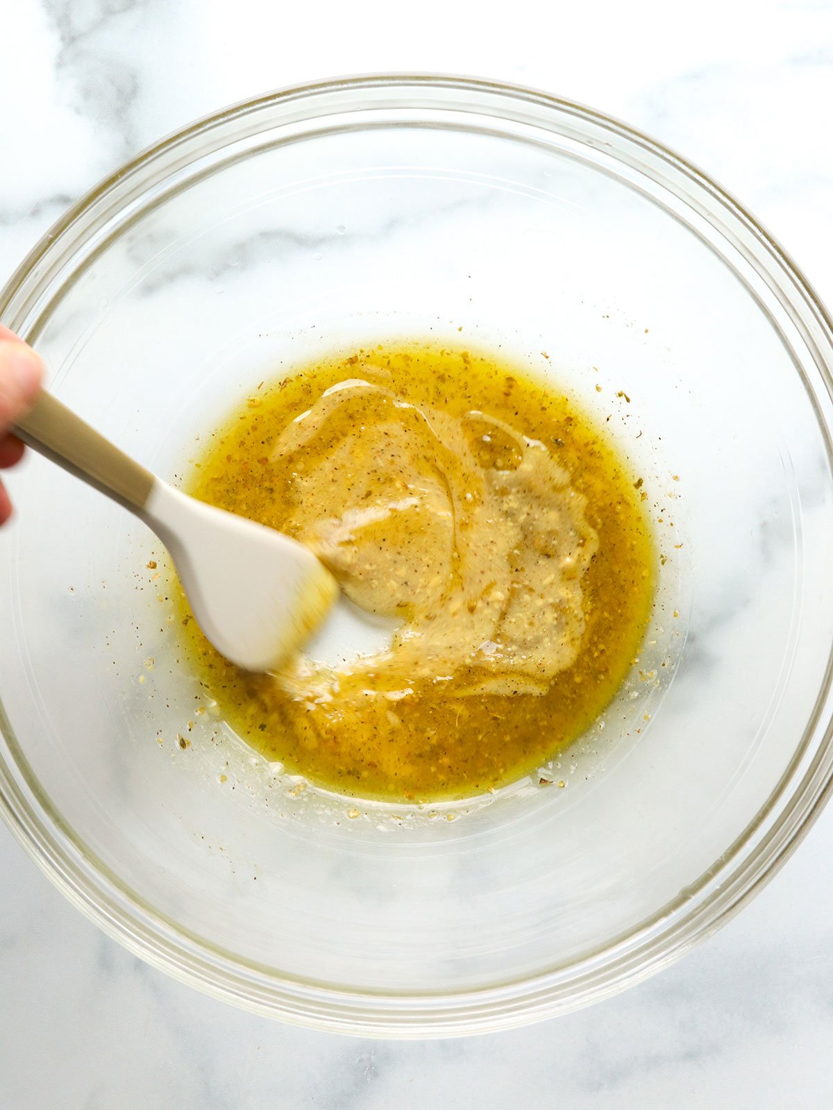 dressing mixed in a glass bowl for kale salad.