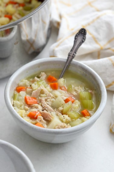 leftover turkey soup in a white bowl