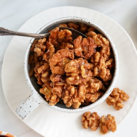 candied walnuts served with a spoon.