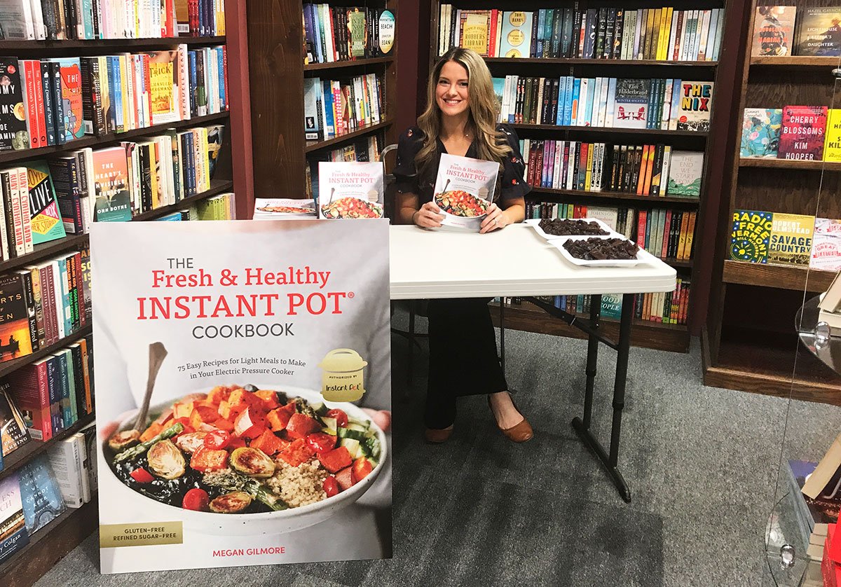 megan gilmore getting ready for a book signing at rainy day books. 