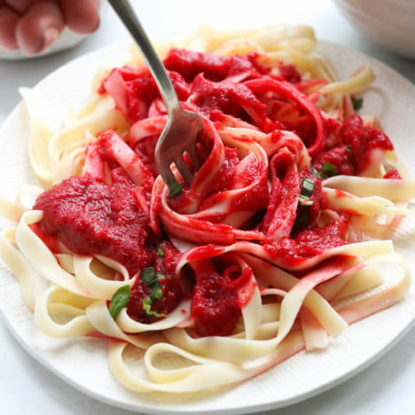 Nomato sauce twirled on a fork with noodles.