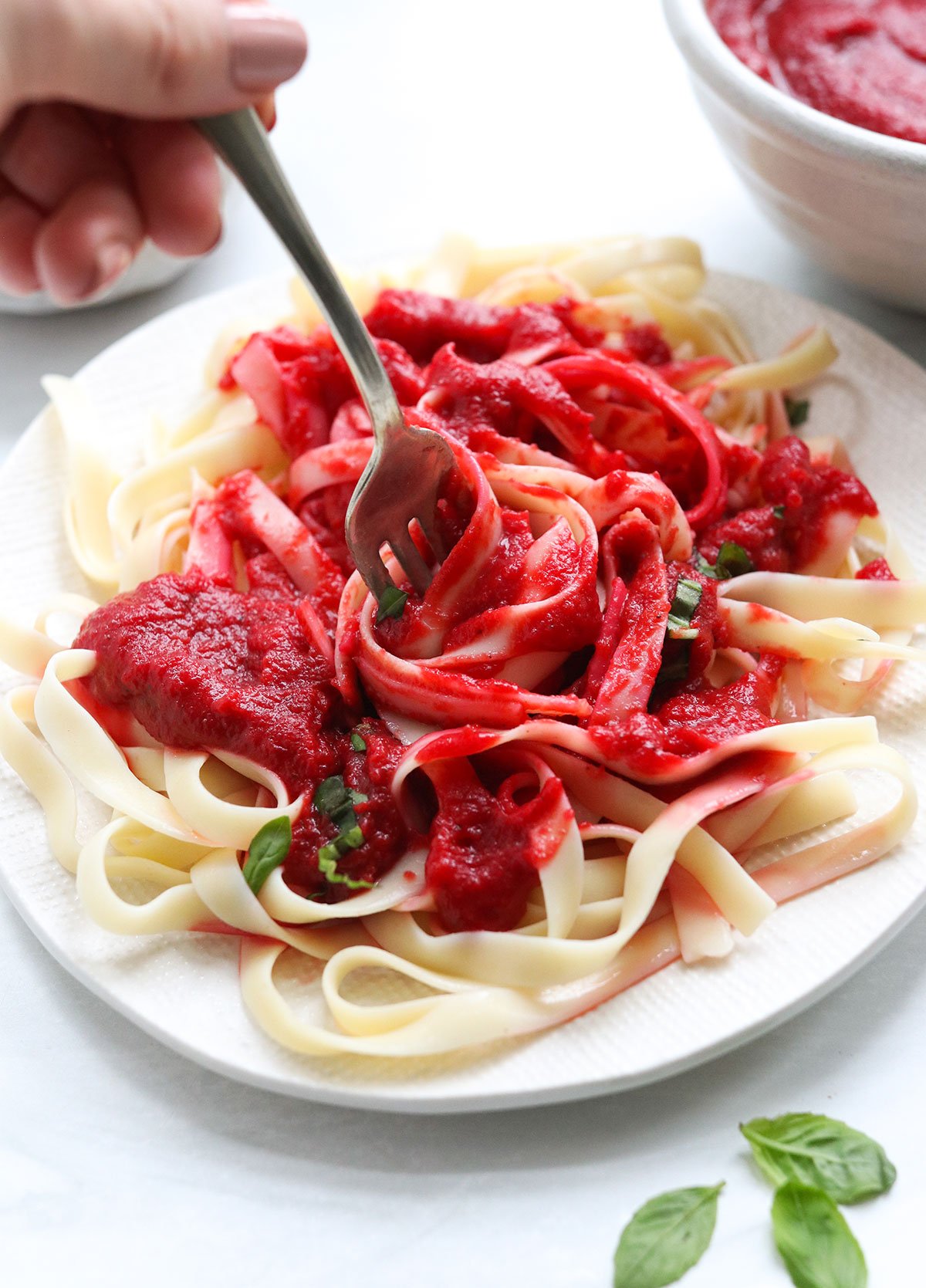 Nomato sauce twirled on a fork with noodles.