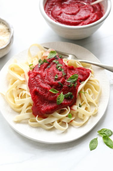 nomato sauce served over pasta with basil.