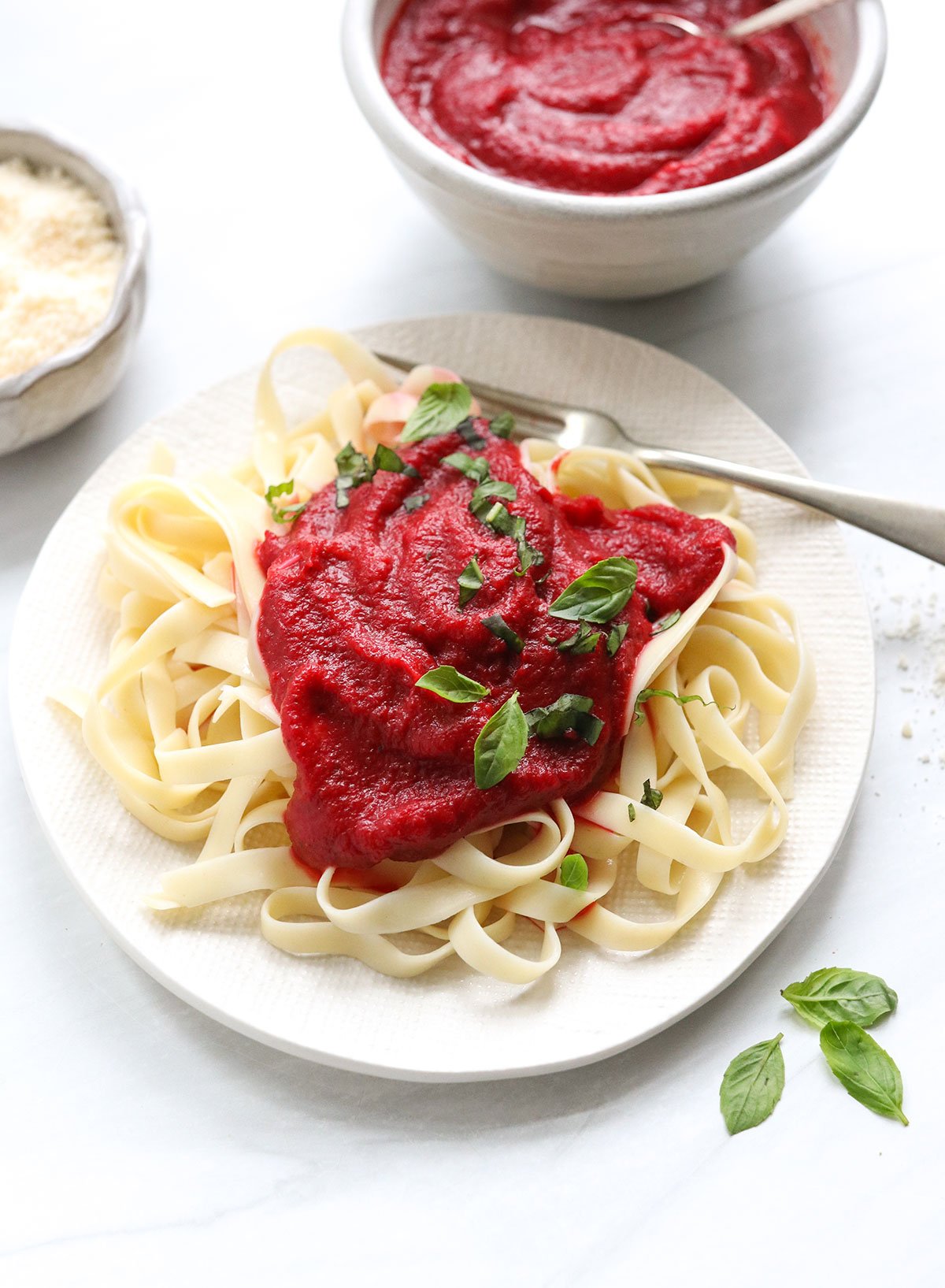 nomato sauce served over pasta with basil.