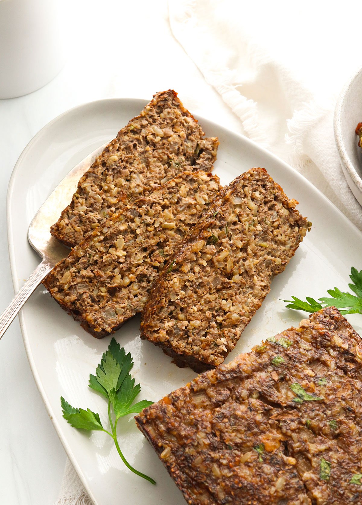 3 slices of nut roast on an oval serving platter.