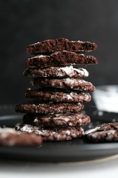 oat flour chocolate cookies stacked on black plate.