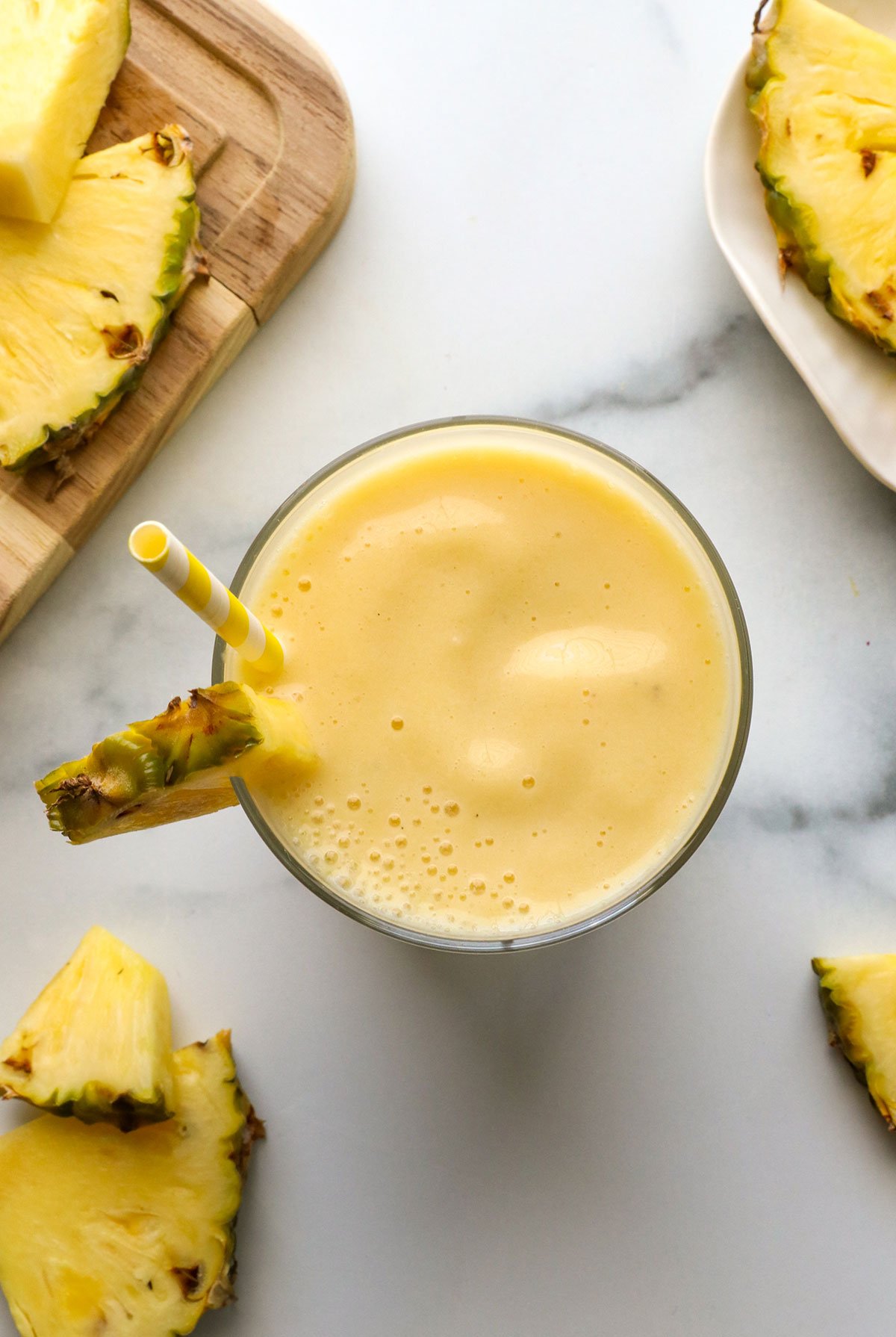 pineapple smoothie in a glass from overhead. 