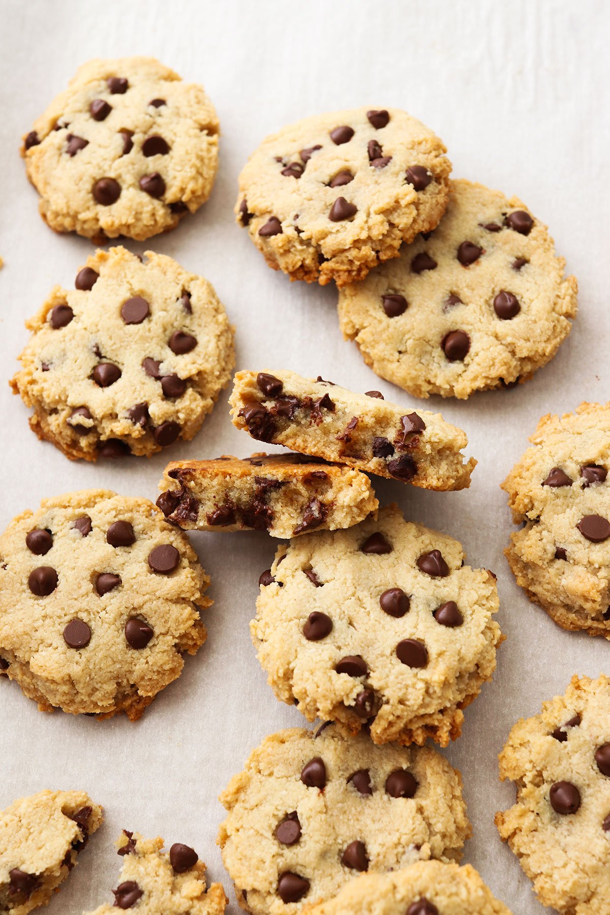 Paleo cookies baked and cooled with one split in half on the pan.